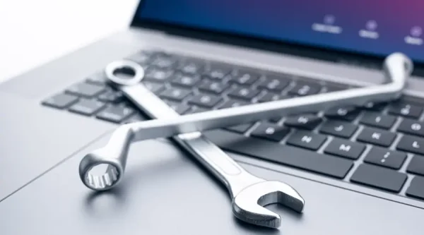 Laptop on a desk with digital tools displayed, representing website maintenance and ongoing support